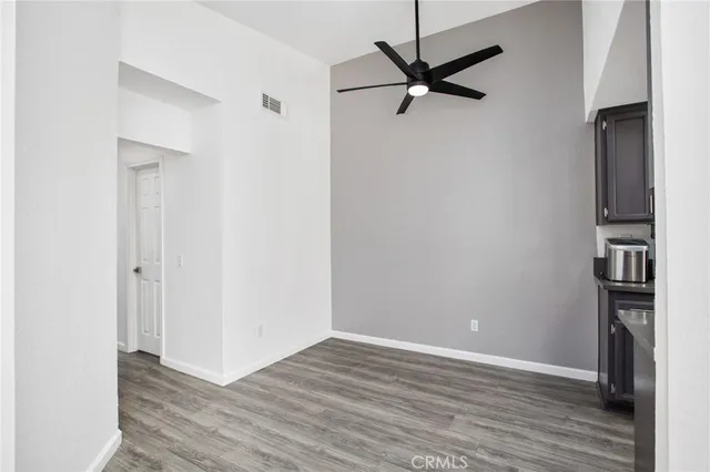 a kitchen with stainless steel appliances granite countertop a refrigerator oven a sink dishwasher and wooden cabinets with wooden floor