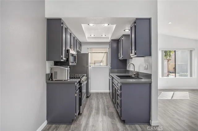 a kitchen with a sink stove and refrigerator