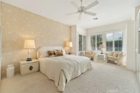 a bedroom with bed couch and window