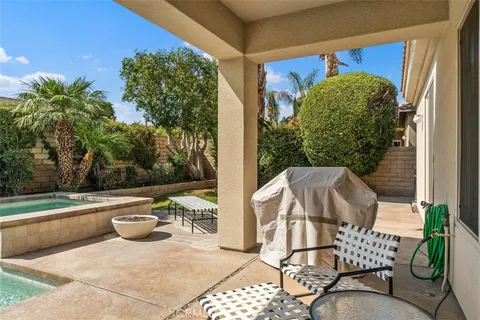 a view of a patio with two chairs and a table