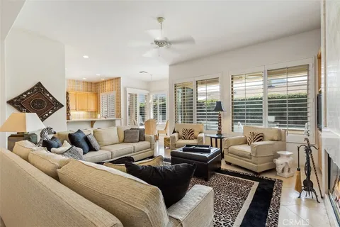a living room with furniture and large windows