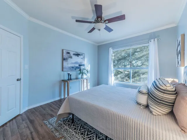 a bedroom with a bed and a chandelier