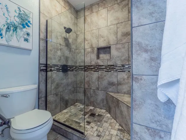 a bathroom with a toilet and a shower