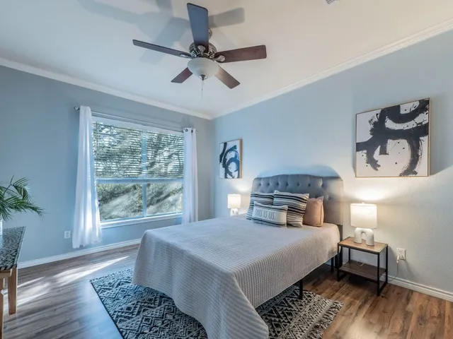 a bedroom with a large bed and a window