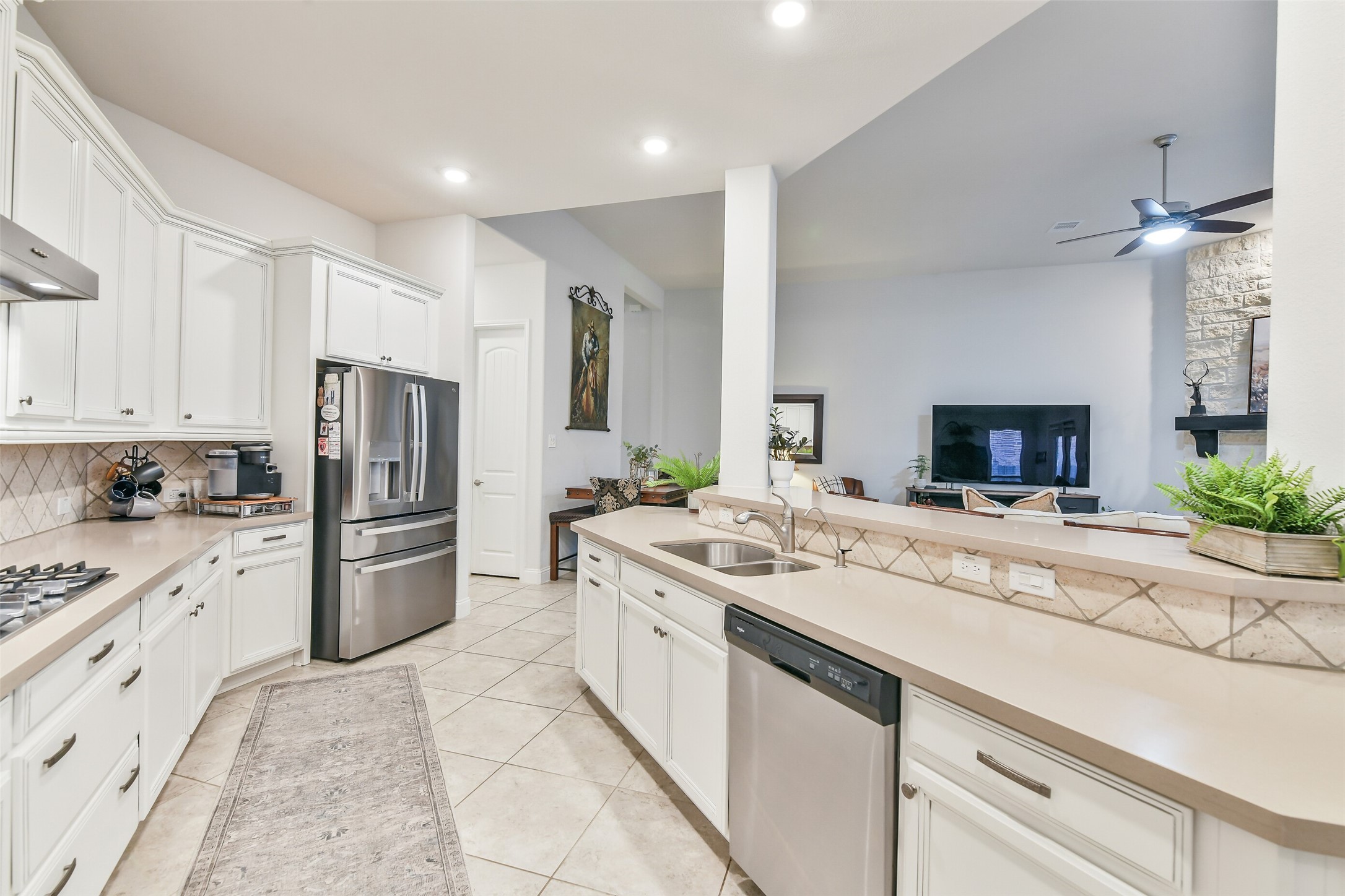 19206 Chestnut Colt Trail Tomball, TX 77377 - Photo 12 of 50 a kitchen with a sink stove and refrigerator
