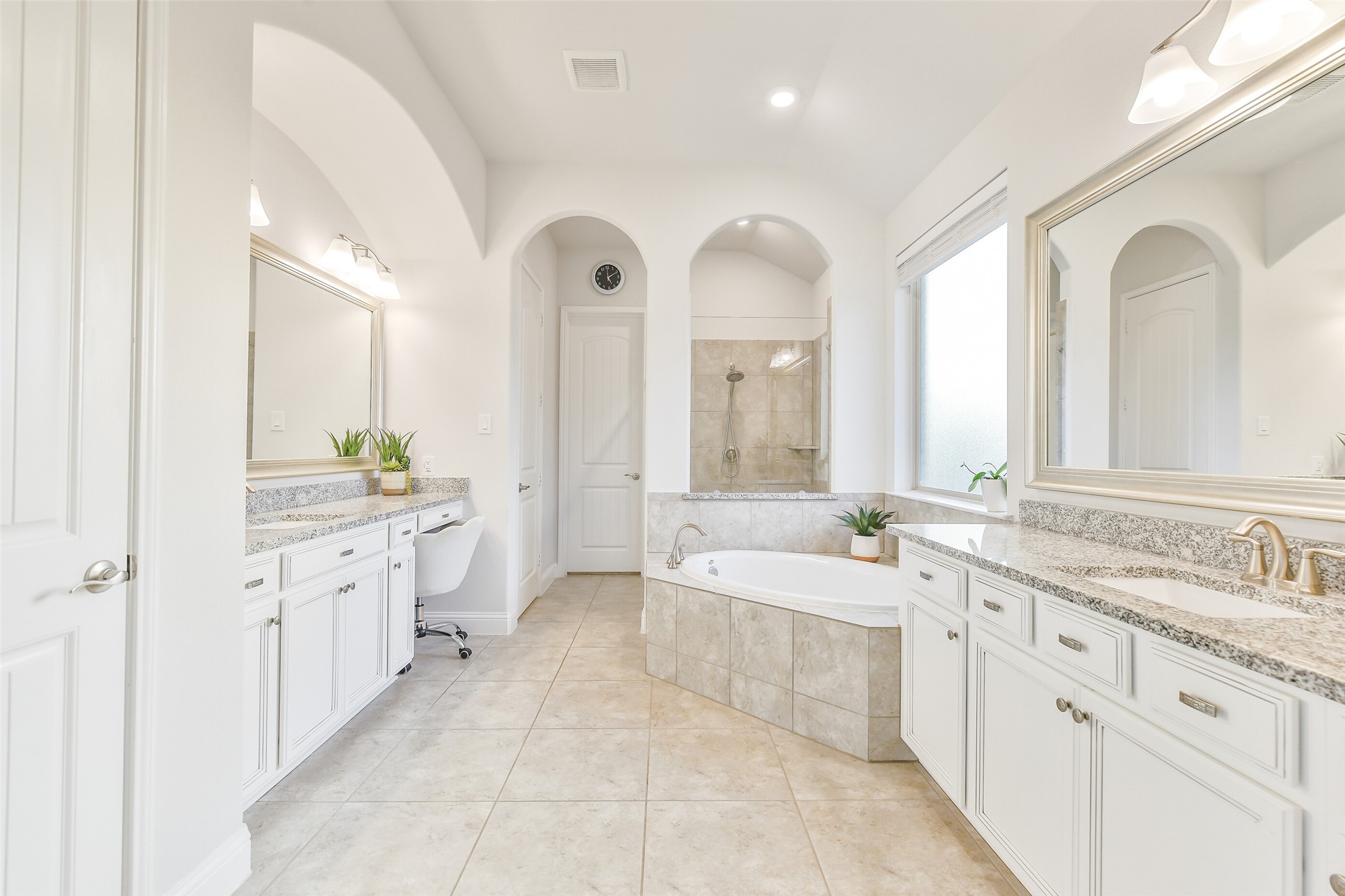 19206 Chestnut Colt Trail Tomball, TX 77377 - Photo 19 of 50 a large bathroom with a granite countertop double vanity sink a mirror and a bathtub