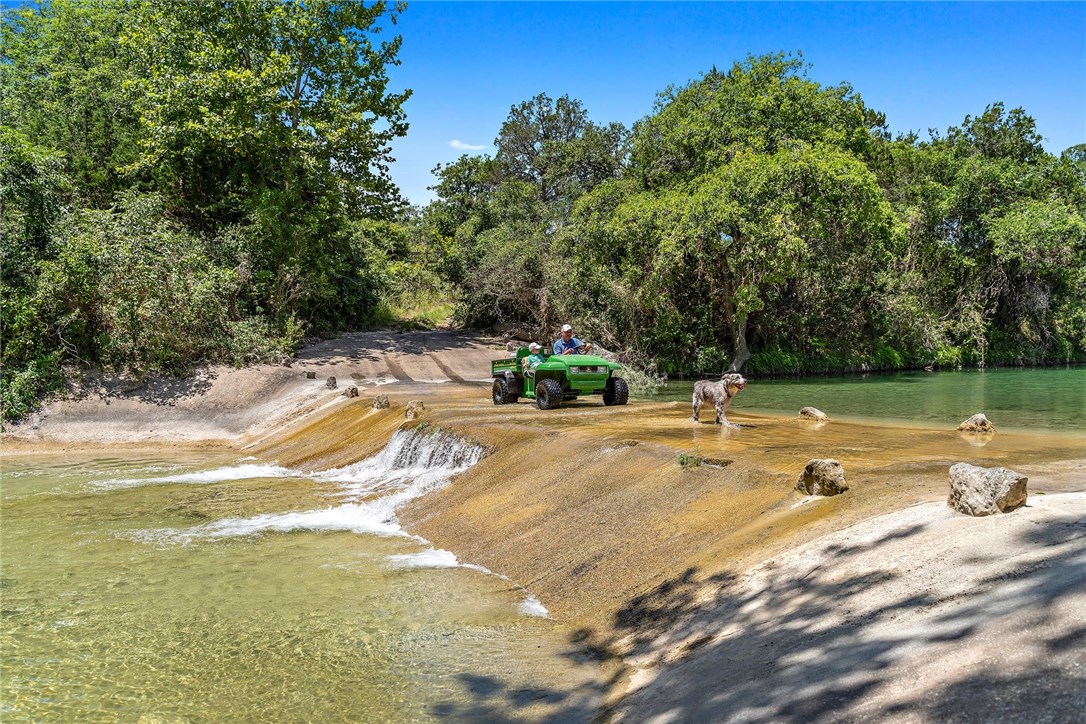 a view of a swimming pool with a yard and sitting area
