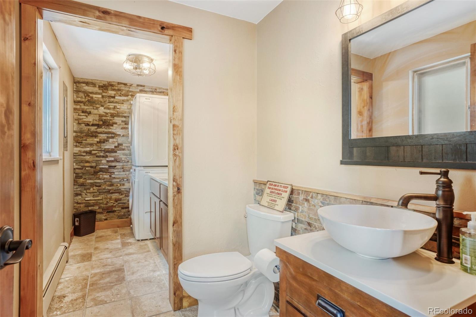 3518 South Saddle Road Evergreen, CO 80439 - Photo 15 of 27 a bathroom with a sink toilet a mirror and shower