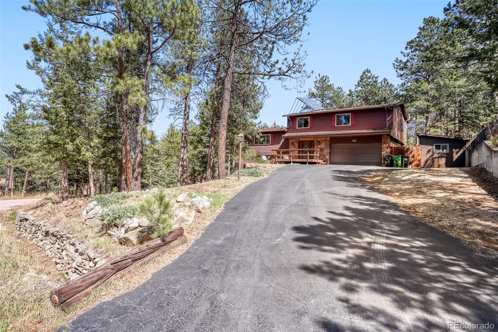 3518 South Saddle Road Evergreen, CO 80439 - Photo 2 of 27 a view of a house with a yard covered in snow