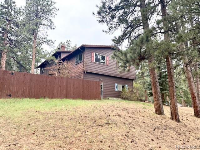 3518 South Saddle Road Evergreen, CO 80439 - Photo 22 of 27 a front view of a house with a yard and garage