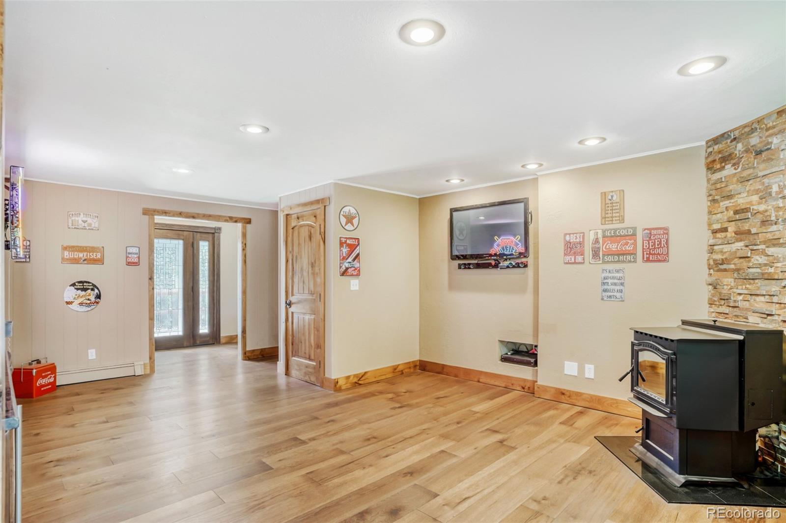 3518 South Saddle Road Evergreen, CO 80439 - Photo 3 of 27 a bedroom with a bed and wooden floor