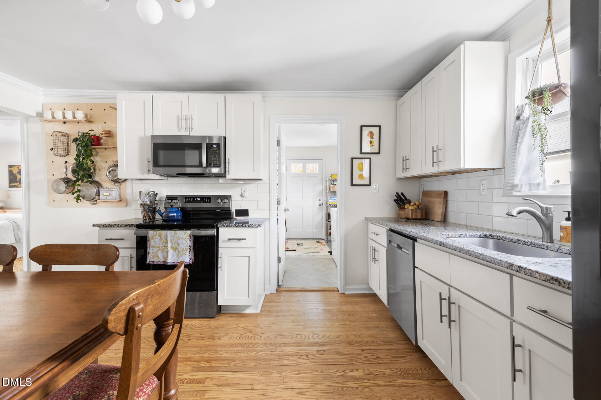 608 Canal Street Durham, NC 27701 - Photo 3 of 36 a kitchen with cabinets stainless steel appliances a sink and a center island