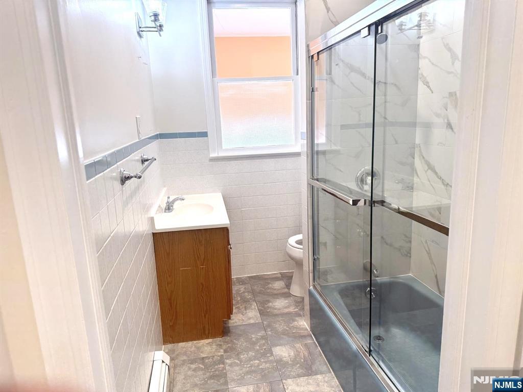210-212 Maple Street, Unit 2 Kearny, NJ 07032 - Photo 9 of 9 a bathroom with a sink and a shower