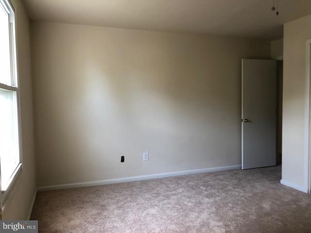 6427 Walther Avenue, Unit E Baltimore, MD 21206 - Photo 13 of 17 an empty room with a window