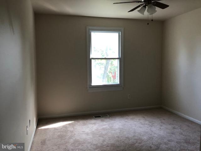 6427 Walther Avenue, Unit E Baltimore, MD 21206 - Photo 7 of 17 an empty room with a window
