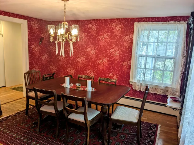 a view of a dining room with furniture and chandelier