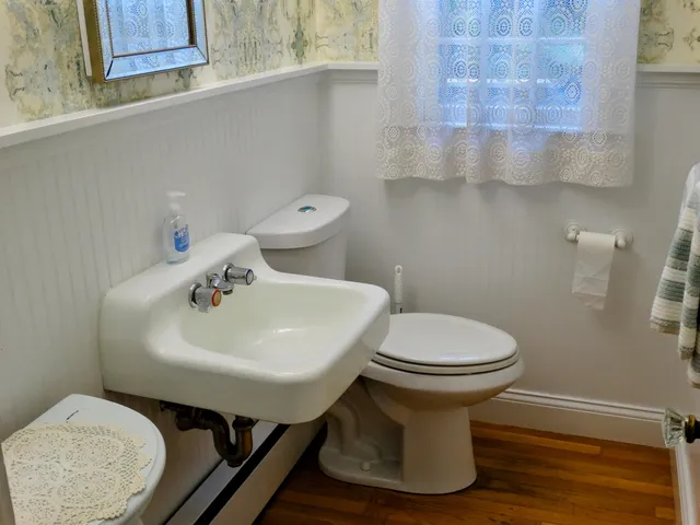 a bathroom with a sink toilet and a mirror