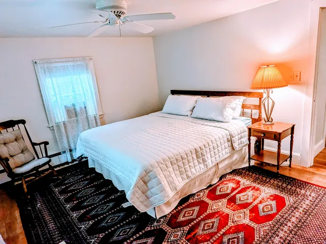 a bedroom with a bed and a window