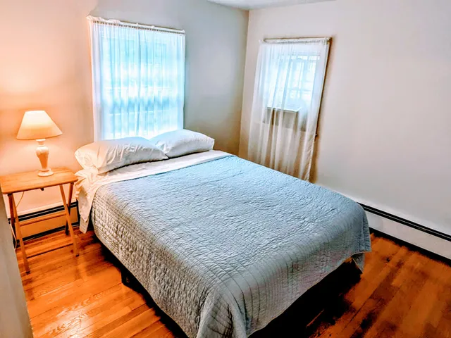 a bedroom with bed and window