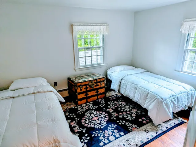 a bedroom with a bed window and a lamp
