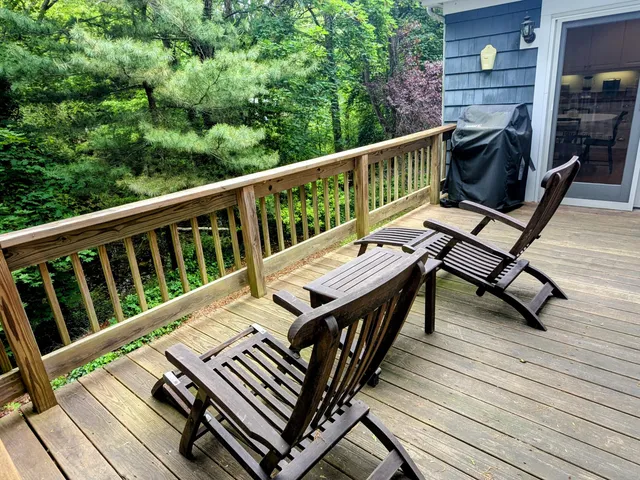 a view of a balcony with wooden floor and outdoor seating
