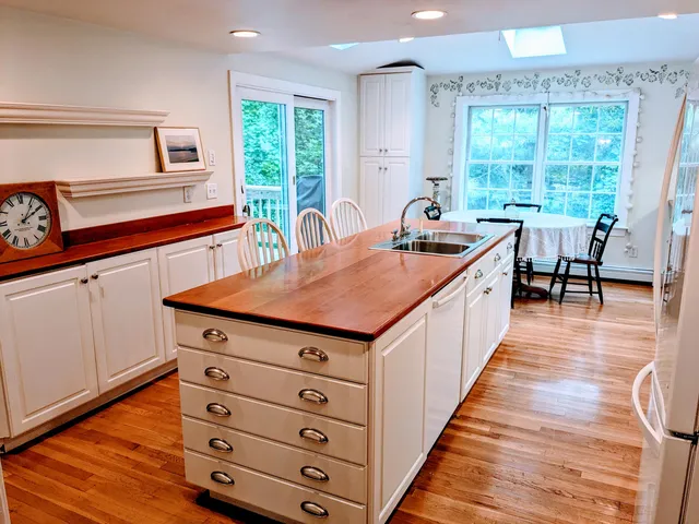 a kitchen with a stove a sink and a refrigerator