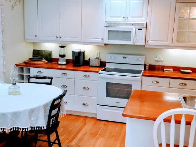 a kitchen with stainless steel appliances a stove a sink and a refrigerator