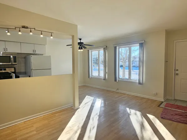 a view of livingroom with hardwood floor and a ceiling fan