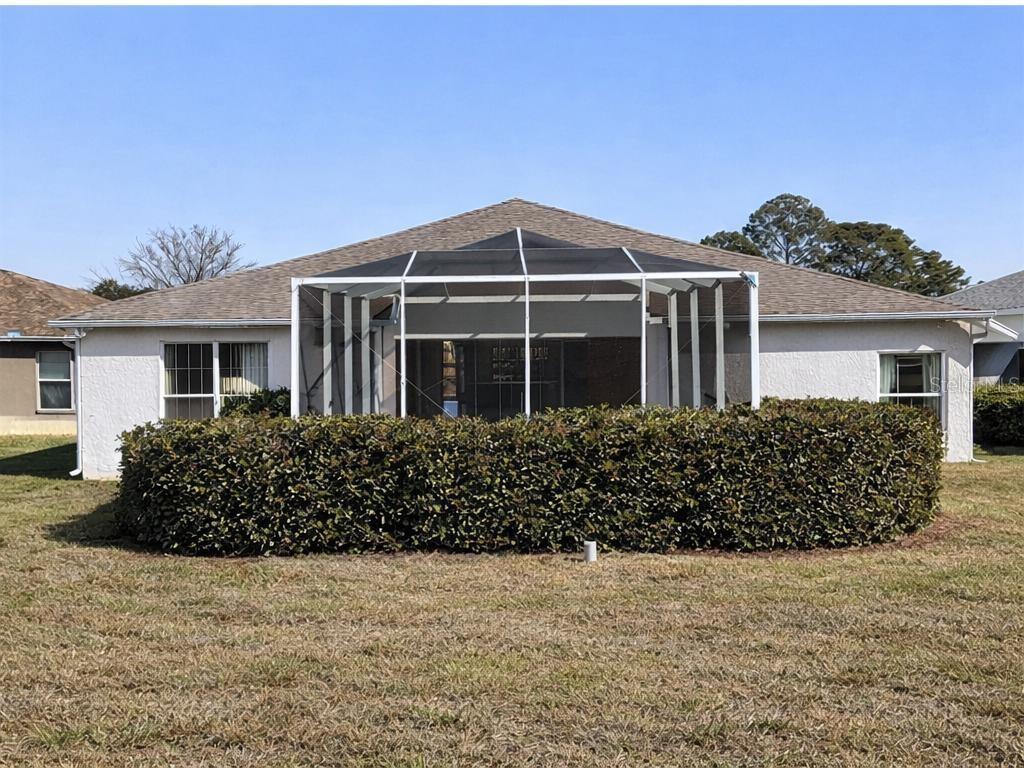 15296 Southwest 15th Terrace Road Ocala, FL 34473 - Photo 2 of 15 a front view of a house with a garden