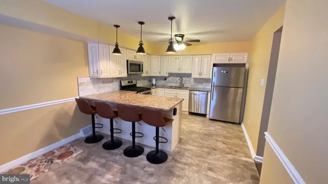 a kitchen with refrigerator and table