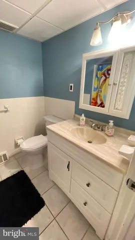 a bathroom with a sink a toilet and mirror