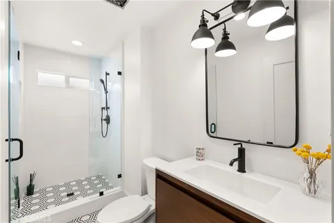 a bathroom with a sink vanity granite and a mirror