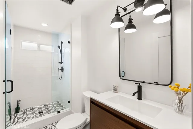 a bathroom with a sink vanity granite and a mirror