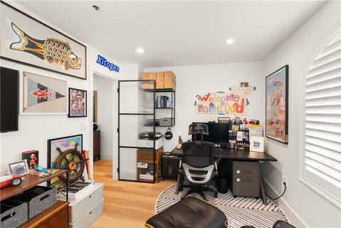 a view of a workspace with furniture and a window