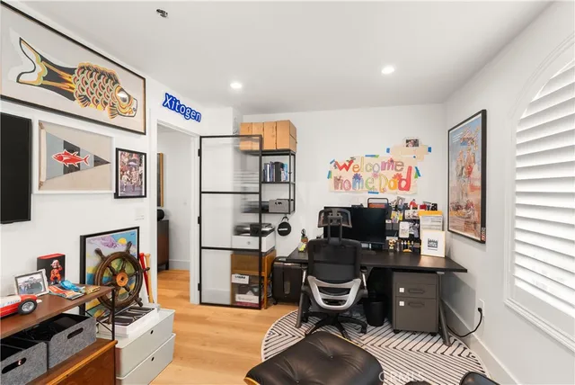 a view of a workspace with furniture and a window