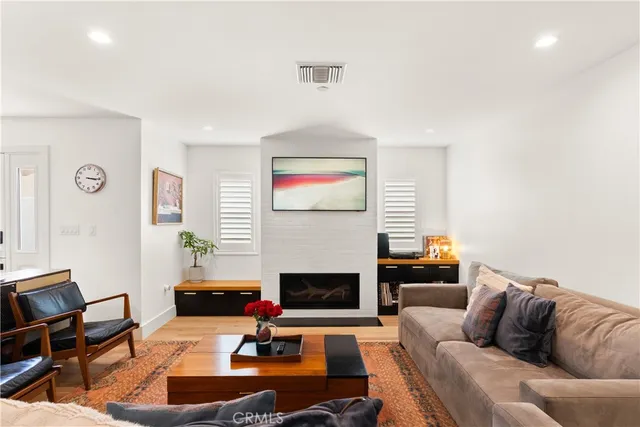 a living room with furniture fireplace and a flat screen tv