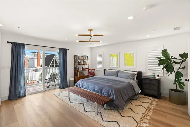 a bed room with a bed and a potted plant