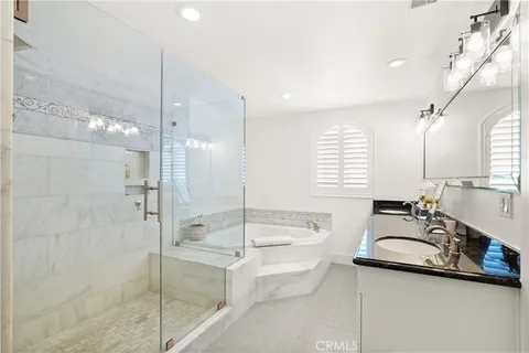 a bathroom with a tub sink toilet and a mirror