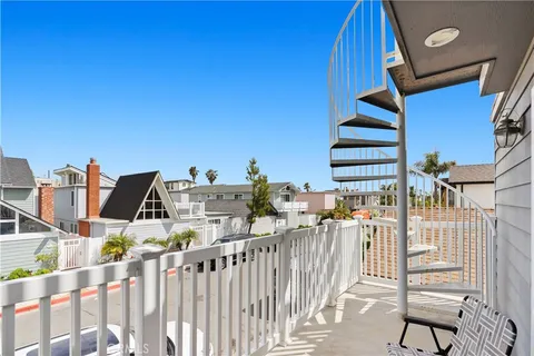 a view of a balcony with wooden floor and fence
