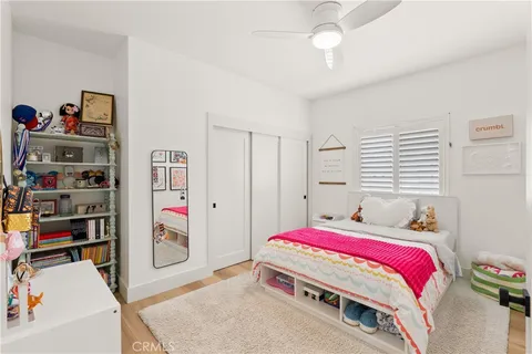 a bedroom with bed and a book shelf