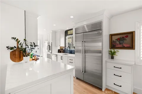 a kitchen with stainless steel appliances a refrigerator and a stove