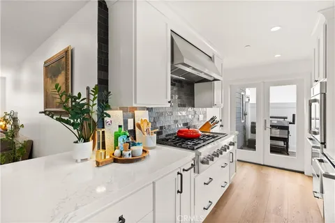 a kitchen with a sink appliances and cabinets