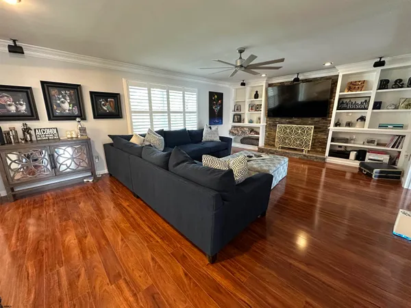 a living room with couches and a coffee table with wooden floor