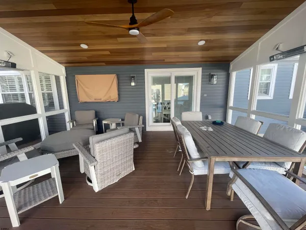 a living room with fireplace furniture and a large window
