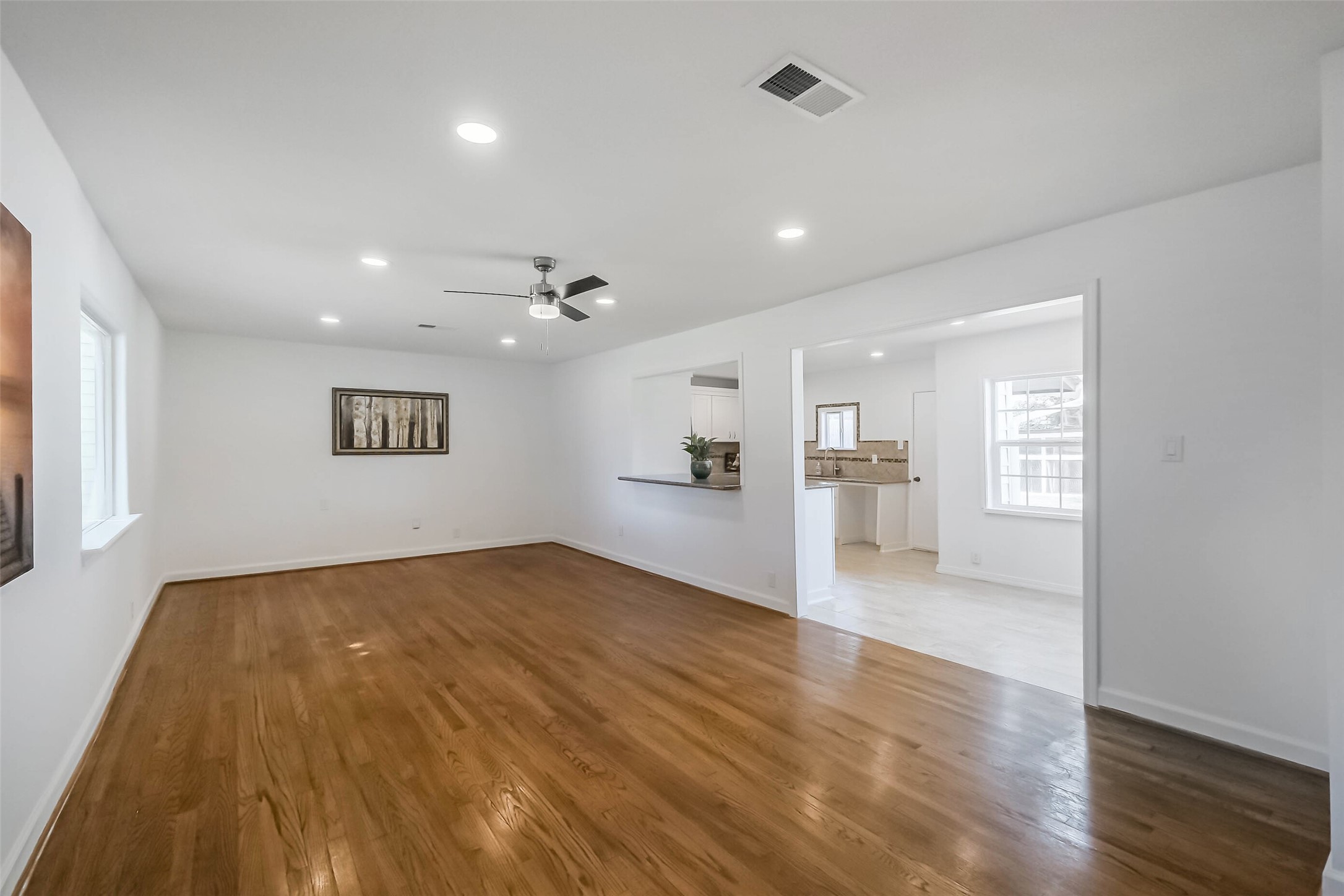 7543 Greenstone Street Houston, TX 77087 - Photo 4 of 24 a view of empty room with wooden floor and windows