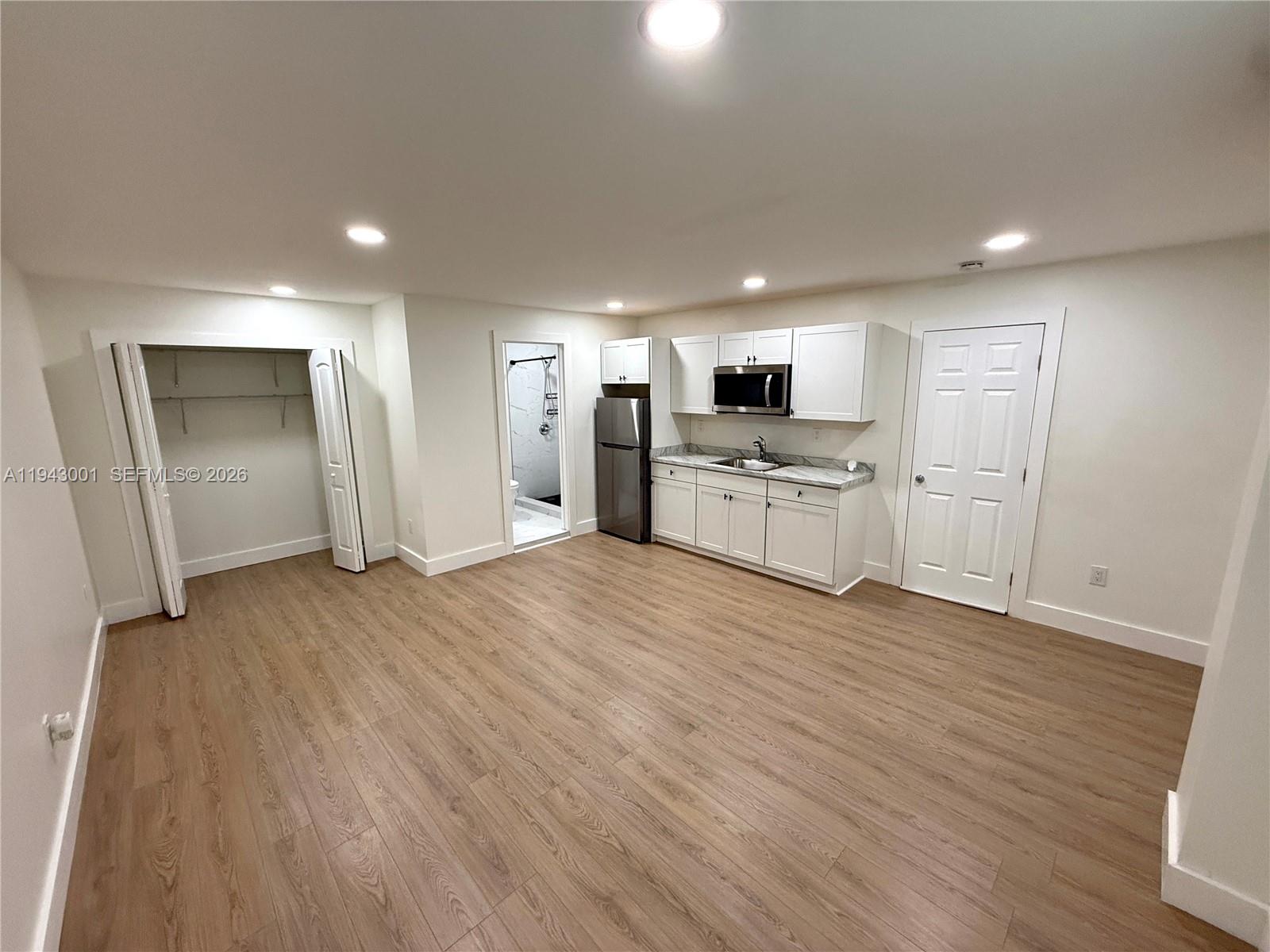 2120 Southwest 83rd Avenue Miami, FL 33155 - Photo 4 of 8 a view of a kitchen with a sink and a refrigerator