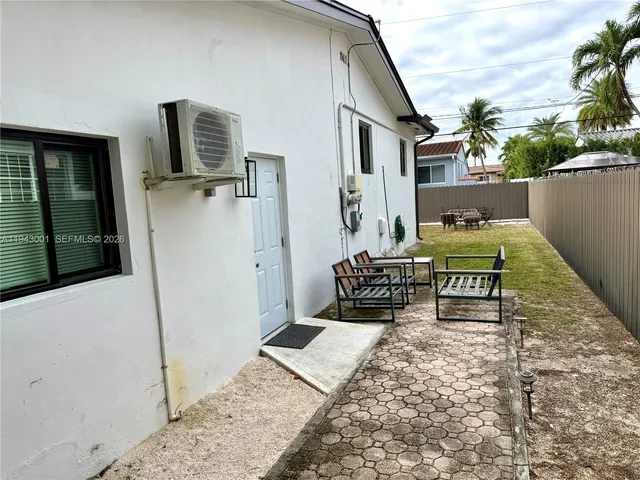 a balcony with chairs and a rug