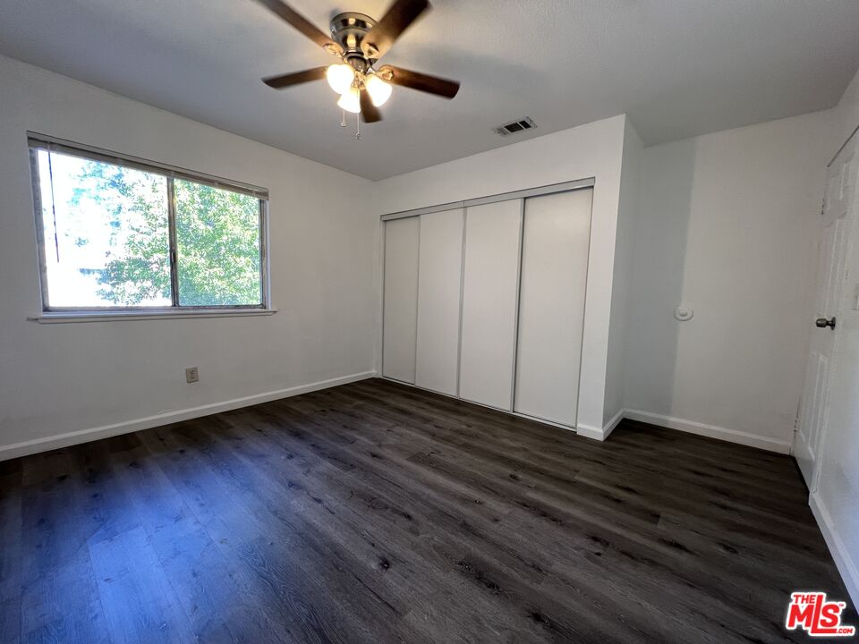 418 West Jackson Street Rialto, CA 92376 - Photo 22 of 24 a view of an empty room with wooden floor and a window