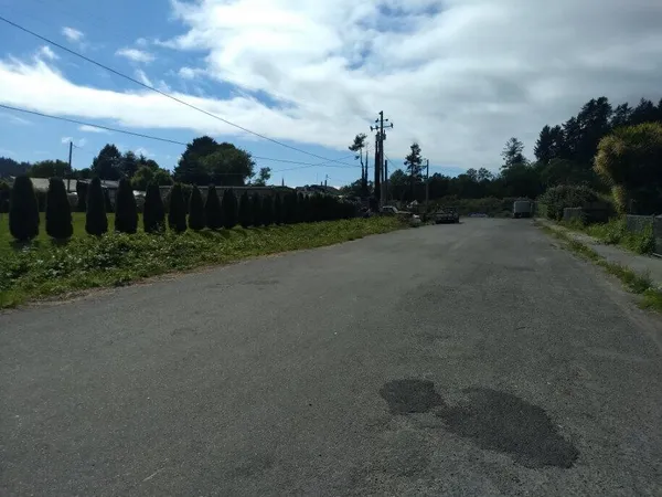 a view of a city street next to a building