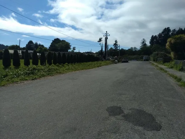 a view of a city street next to a building